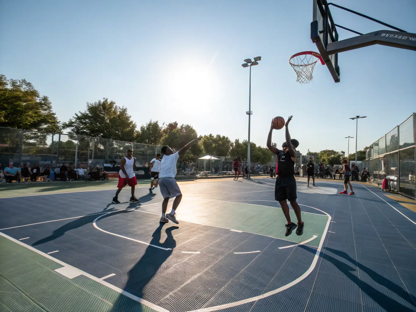 An action shot of individuals playing basketball in an indoor court, emphasizing the energy and excitement of the sport. The players are focused and engaged, highlighting the competitive yet friendly atmosphere.